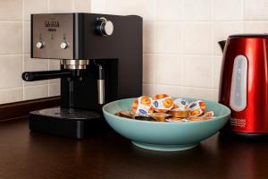 a bowl of food sitting next to a coffee maker at B&B Casa Fortunata in Milan