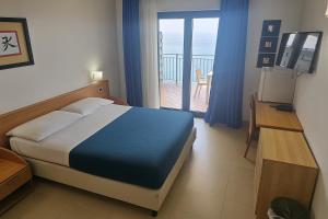a bedroom with a bed and a view of a balcony at Casa Rossa 1888 in Torre del Greco +26 photos