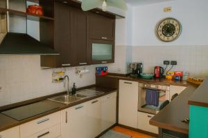 a kitchen with a sink and a microwave at B&B Casa Fortunata in Milan