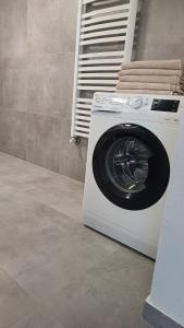 a washing machine is sitting in a bathroom at Pokoje gościnne u Majerczyków in Stozh