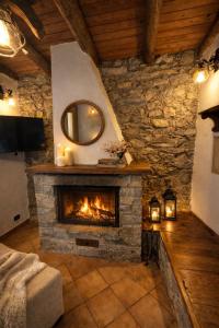 a living room with a stone fireplace with a mirror at Altamarea Private Retreat in Corniglia