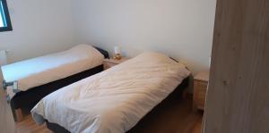 a bedroom with two beds and a night stand at Gite du Châtelard in Thiébouhans