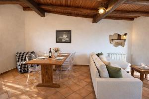 a living room with a table and a couch at Altamarea Private Retreat in Corniglia