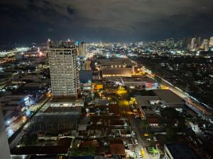 a city skyline at night with a tall building at SM Cebu City Sunvida Tower Condominium in Cebu City