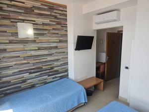 a bedroom with a wall made out of wood at Casa Rossa 1888 in Torre del Greco