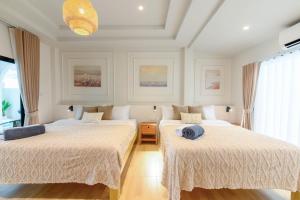 two beds in a room with white walls at Villa Luna and Villa Solara in Koh Samui +193 photos
