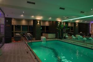 a large swimming pool in a hotel room at Grand Hotel & Spa Tirana in Tirana