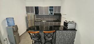 a kitchen with a counter with a microwave and a stove at Square Resident in Monrovia