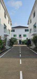 an empty parking lot in front of a building at Square Resident in Monrovia