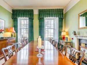 a dining room with a long table and chairs at Ladywell House in Falkland +24 photos