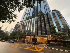 a building on a city street with a building at IKON SUITE's E A T O N KLCC in Kuala Lumpur
