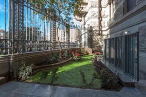 a garden in front of a wrought iron fence at The Place in Milan