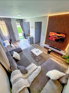a living room with a couch and a fireplace at Graphite & Gold Suite in Ruiru