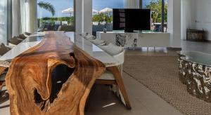 a large wooden table with chairs around it in a living room at Super views in Mykonos in Psarou