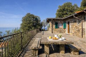 a table with fruit on a balcony of a house at Altamarea Private Retreat in Corniglia