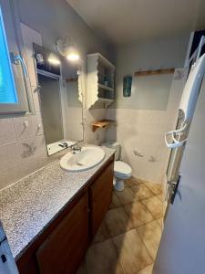 a bathroom with a sink and a toilet at La Canotière in Saint-Georges-dʼOléron