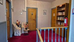 a room with a staircase and a door and a chair at Le sélect in Néris-les-Bains
