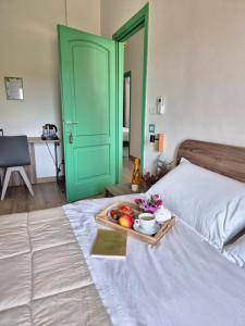 a bed with a tray of fruit on top of it at Abaton - Casa vacanza in Metaponto