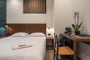 a hotel room with a bed and a desk with a computer at The Place in Milan