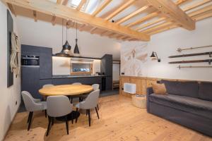 a living room with a table and a couch at Breithorn Lodge in Champoluc