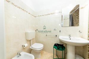 a bathroom with a toilet and a sink at Casa di Levante - Gallipoli in Gallipoli