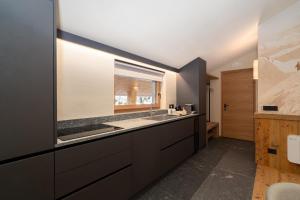 a bathroom with a sink and a counter with a window at Breithorn Lodge in Champoluc +80 photos