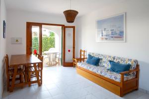a living room with a couch and a table at Villa Marta in Cala Blanca