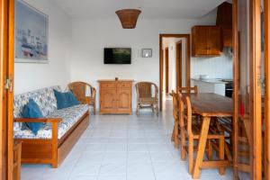a living room with a couch and a table at Villa Marta in Cala Blanca