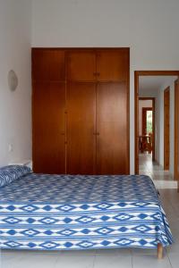 a bedroom with a bed and a wooden cabinet at Villa Marta in Cala Blanca +11 photos