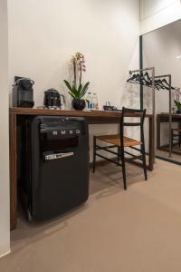 a kitchen with a stove and a table and a chair at The Place in Milan