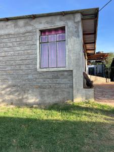 a building with a window on the side of it at Mara oasis in Mara Simba