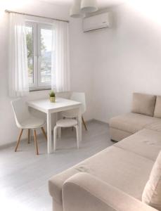 a white living room with a table and a couch at Villa Una Maris - renovated 2026 in Pag +41 photos
