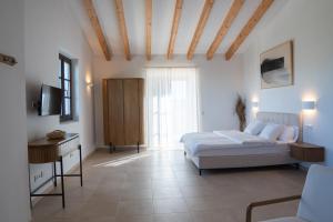 a bedroom with a bed and a table and a television at Vino Resort Son Amaret in Son Macia +68 photos