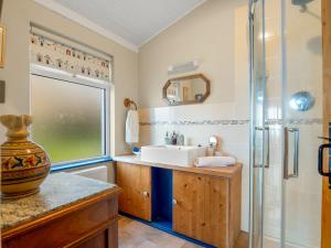a bathroom with a sink and a shower at The Residence Renvyle in Renvyle +50 photos