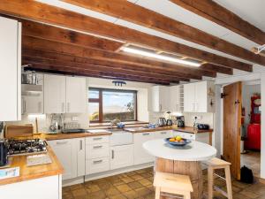 a kitchen with white cabinets and a table at The Residence Renvyle in Renvyle