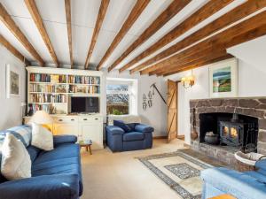 a living room with a blue couch and a fireplace at The Residence Renvyle in Renvyle
