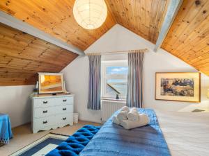 a bedroom with a blue bed and a window at The Residence Renvyle in Renvyle