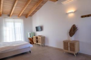 a bedroom with a bed and a tv on a wall at Vino Resort Son Amaret in Son Macia
