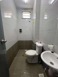 a bathroom with a toilet and a sink at Teratak Amaris Homestay MELAYU ONLY in Sungai Petani +11 photos