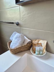 a basket of towels sitting on a counter in a bathroom at Abaton - Casa vacanza in Metaponto +67 photos