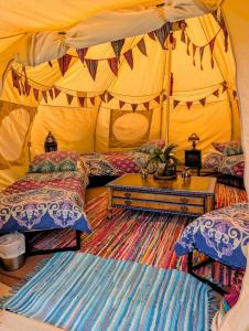 a bedroom with two beds and a tent at Kits Coty Glamping in Maidstone +72 photos