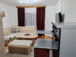 a living room with a couch and a table at Apartman Dačo in Vlasenica