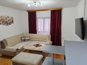 a living room with a couch and a table at Apartman Dačo in Vlasenica