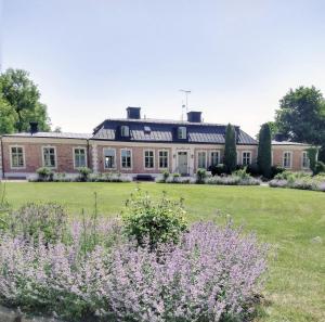 a large house with a lawn and flowers at Wiks Slott in Vik +16 photos