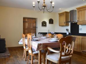a dining room with a table and chairs in a kitchen at Bings Farm House in Whaley Bridge