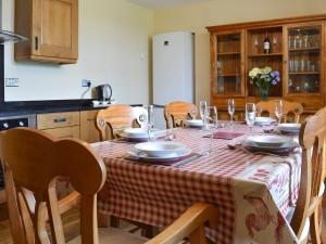 a table with plates and glasses on it in a kitchen at Bings Farm House in Whaley Bridge