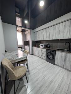 a kitchen with a table and chairs in a room at Gari's apartment next to Borjomi Central Park in Borjomi