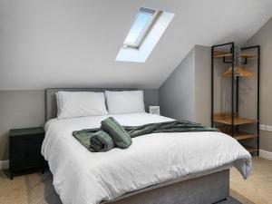 a bedroom with a large bed with green towels on it at Pasture Barn in Barnard Castle