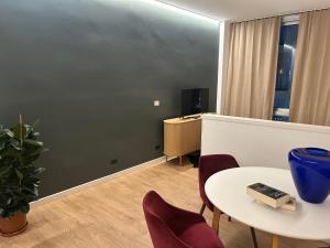 a room with a table and chairs and a desk at Residenze Venezia Apartments in Mestre
