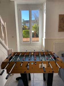 a ping pong table with a bunch of bats on it at Guest House, Private Pool in LʼIsle-en-Dodon